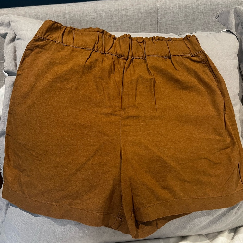 Brown linen like shorts with back pockets. Size medium. Never been worn.